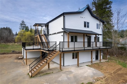 Full exterior of the three-storey Cottam Road residence, showing all three levels and exterior staircases