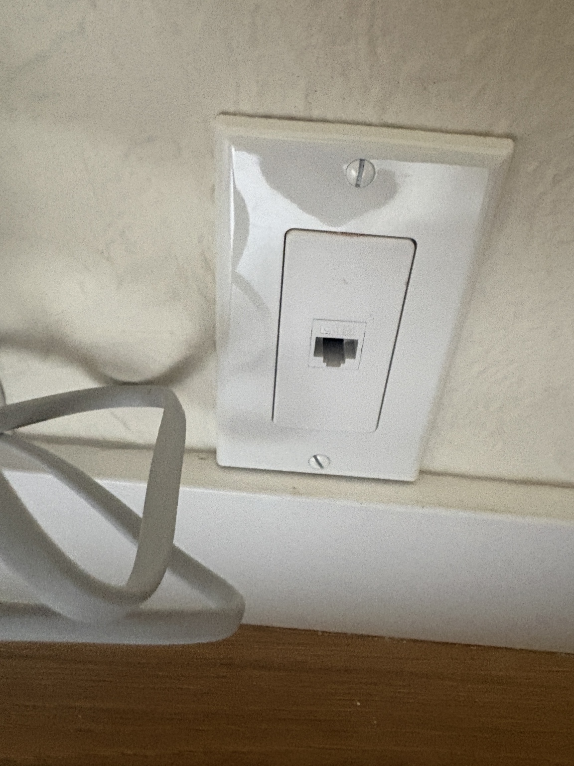 Finished single Ethernet wall outlet above the baseboard